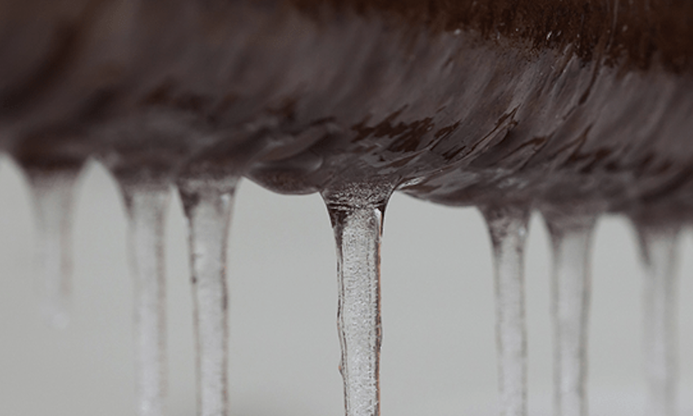 Icicles hanging off a frozen pipe